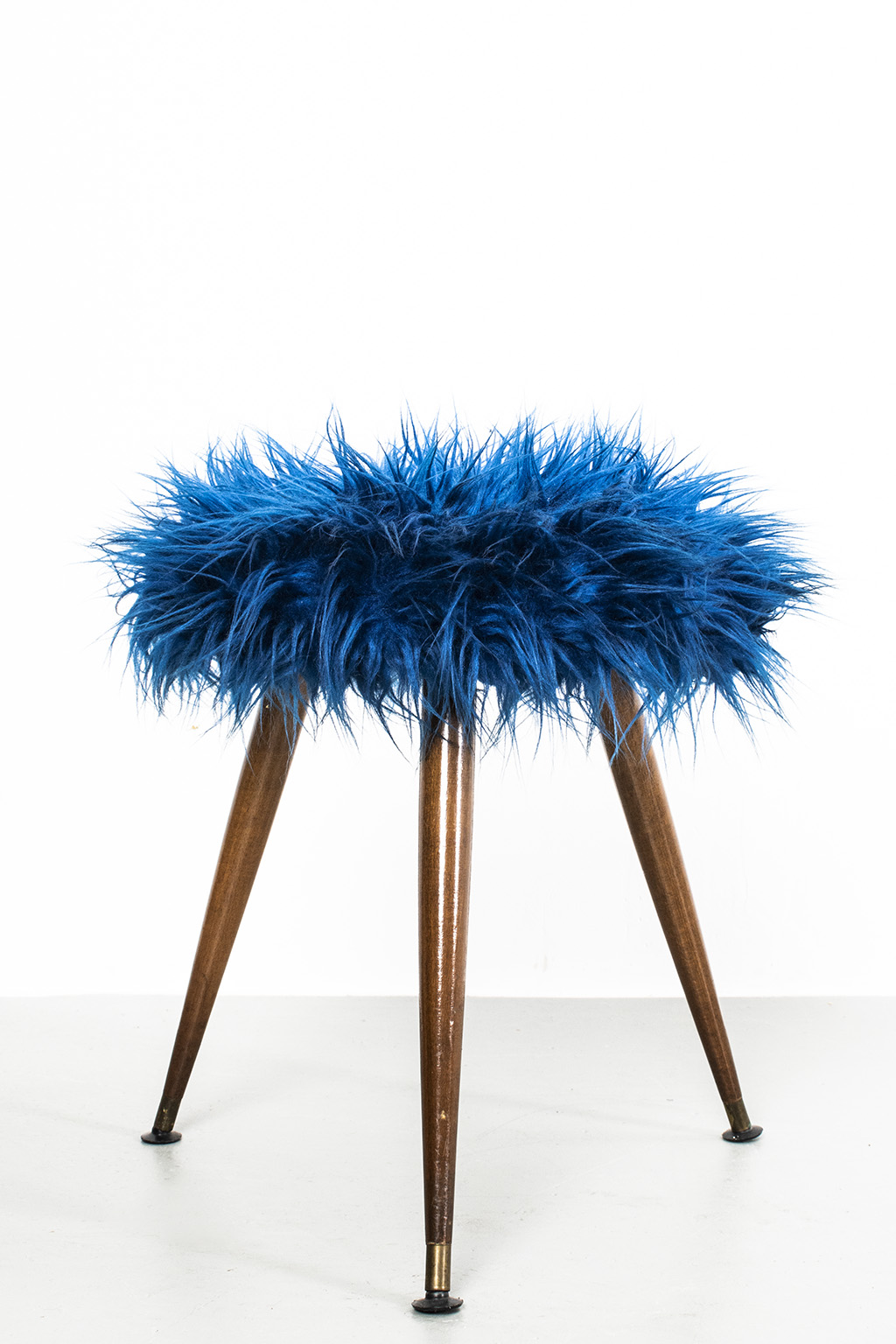 Fluffy blue stool on wooden legs