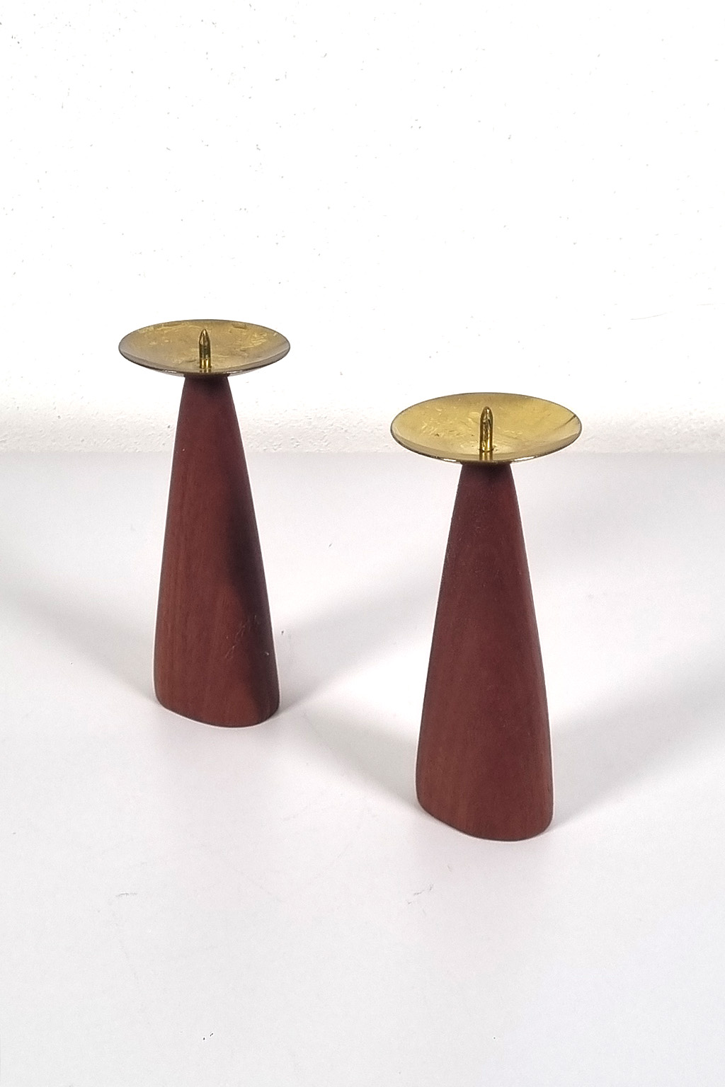 Pair of teak and brass candle holders